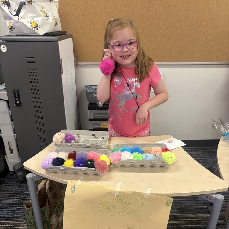 Second graders presenting projects at an economics fair.