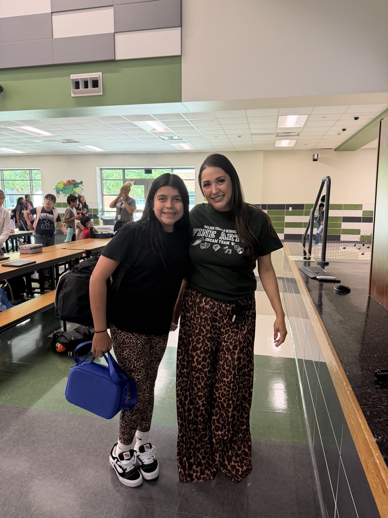 Assistant principal and student in matching leopard print pants