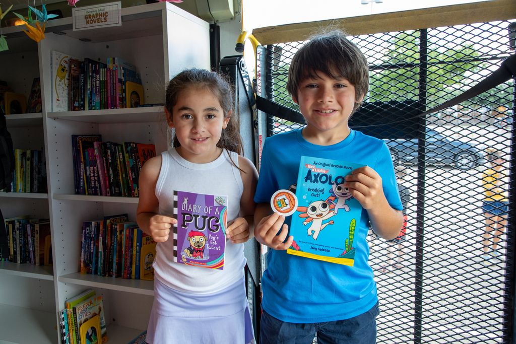 Children pick out a book to take home from the Frisco ISD Book Bus.