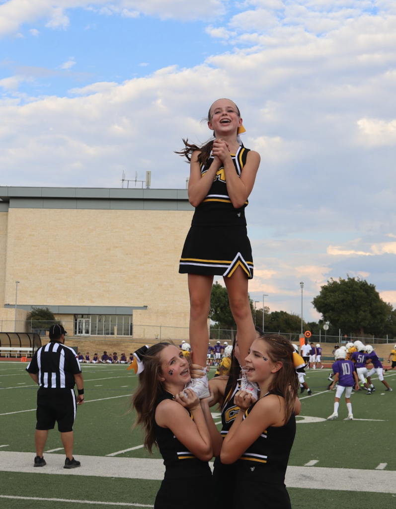 cheerleaders perform a stunt