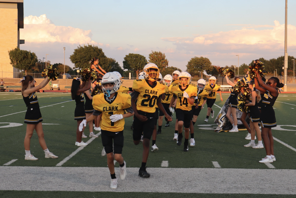 Clark football players running through the cheer victory tunnel