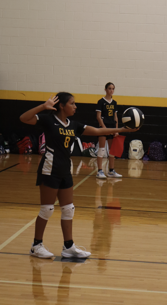 student gets ready to serve ball