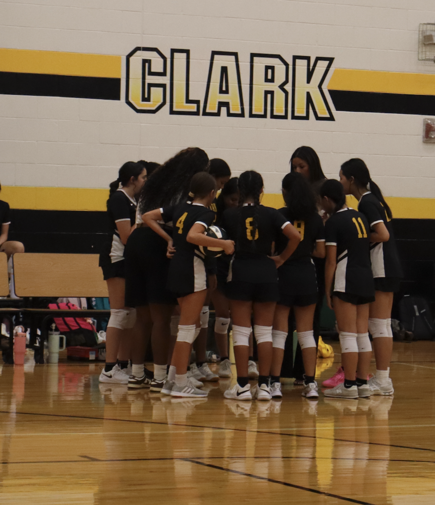 volleyball players huddle to talk about the next play