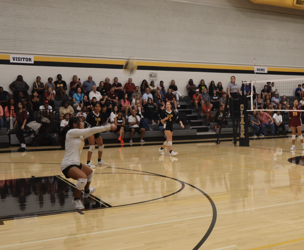 student bumps the volleyball