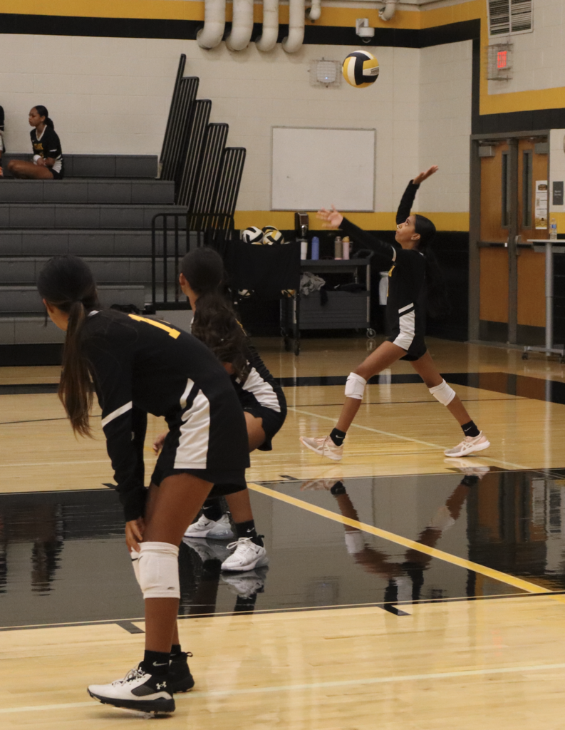 student serves the ball