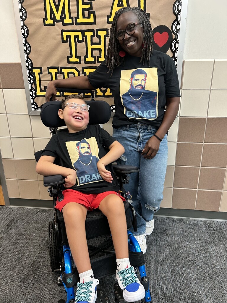 a teacher and student pose with matching shirts