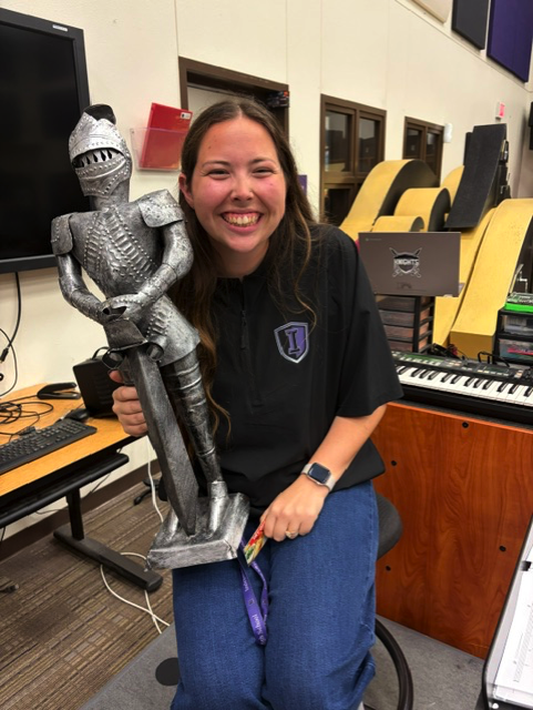 Teacher holding trophy