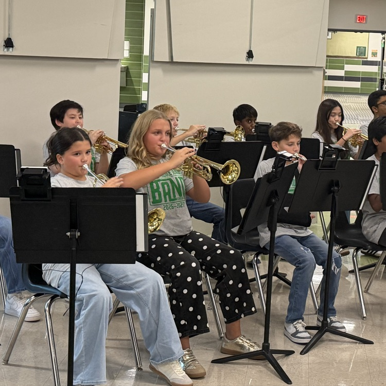 Middle school students performing in a band concert