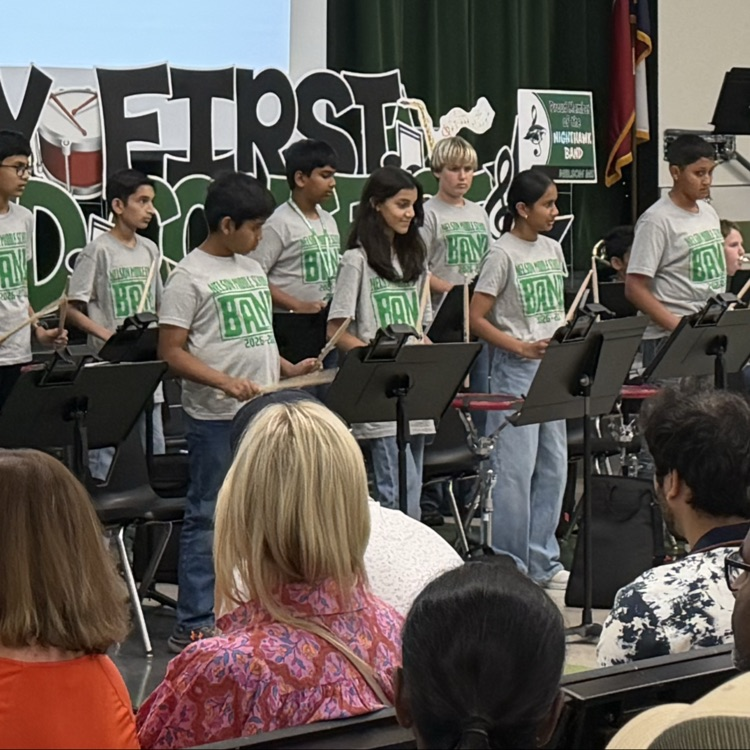 Middle school students performing in a band concert