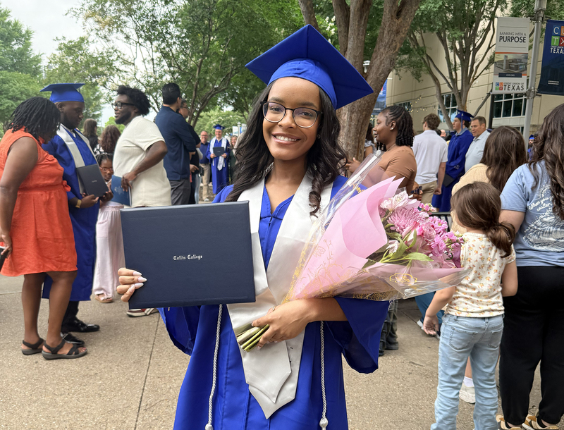 Female student holding a degree