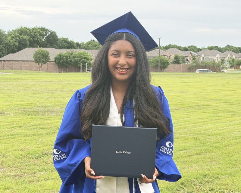 Female student holding a degree