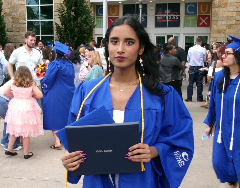 Female student holding a degree