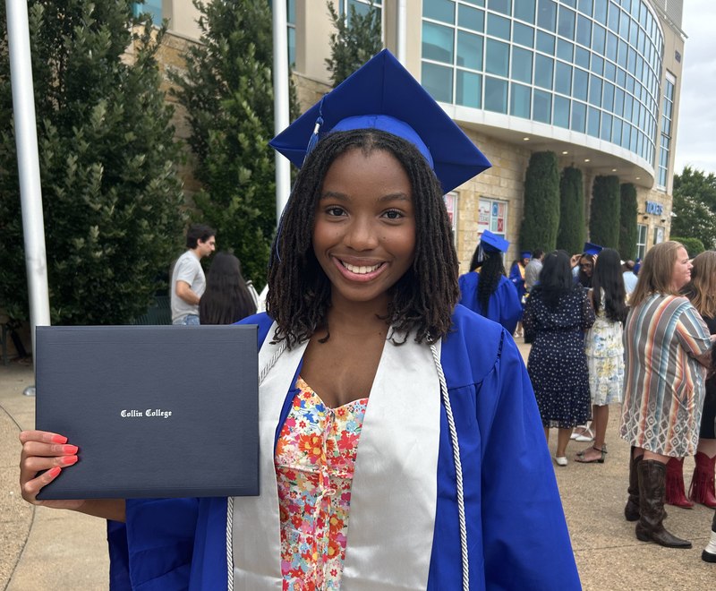 Female student holding a degree