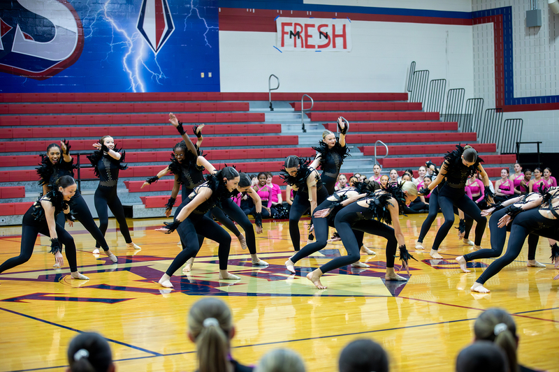 Dance team in black performs at FISD Dance Showoffs