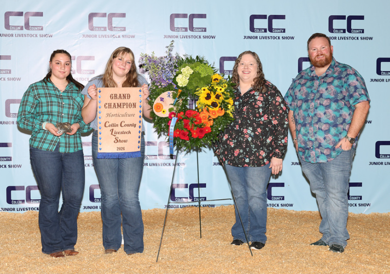 Student and adults with a floral arrangement