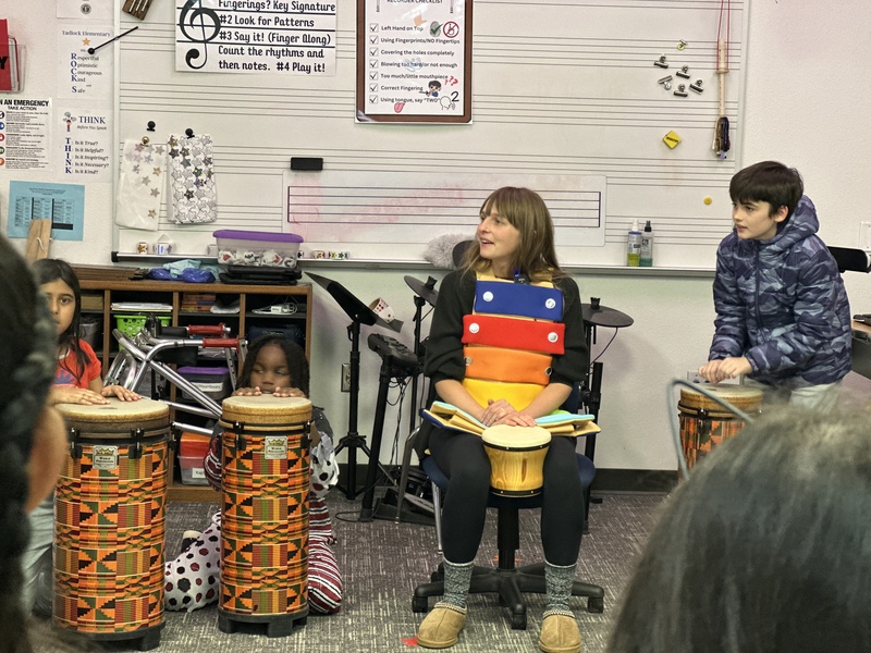 Teacher talking to students in music class