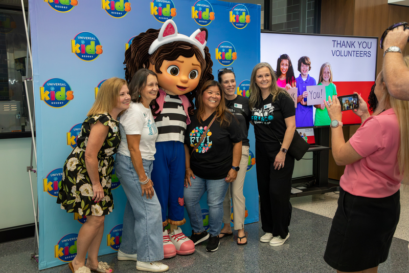 New staff take photos with Gabby of Gabby's Dollhouse