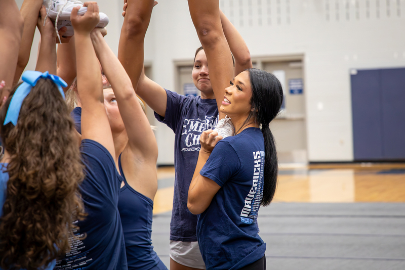Cheer captains act as base for a stunt.
