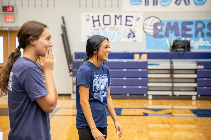 Cheer captains laugh with their team.