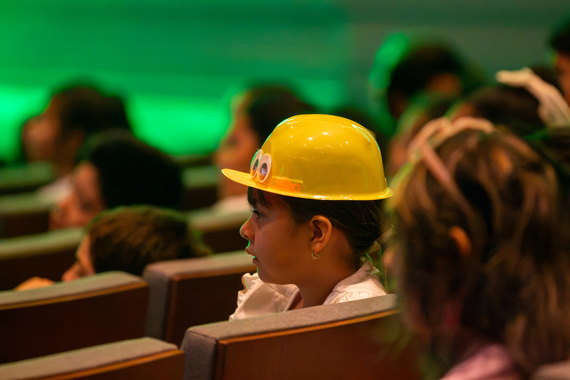 A student wears a duck hat given out by the performers.