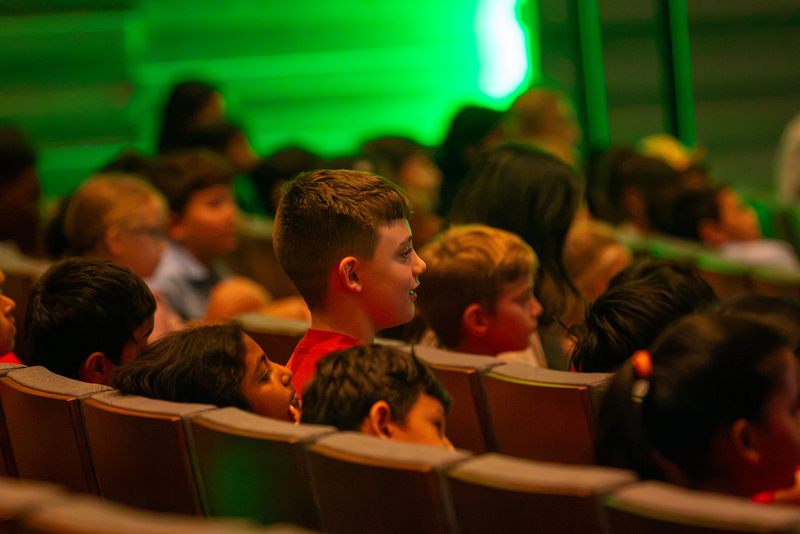 A student sits on the edge of his seat during the opera performance.