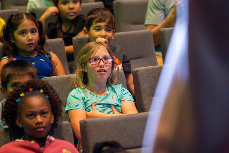 Students watch the opera performance.