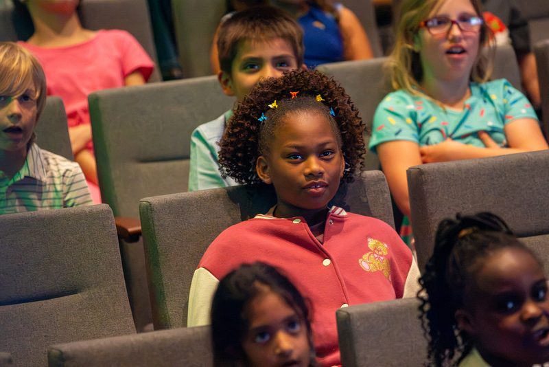 Students watch the opera performance.