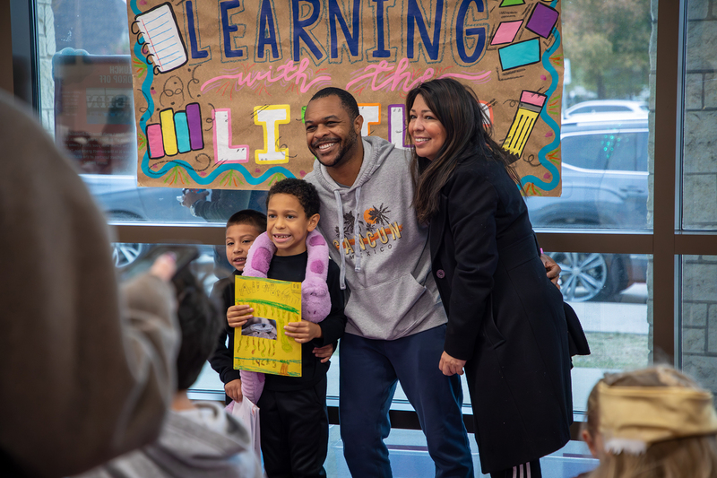 Parents with their student, who has a toy snake