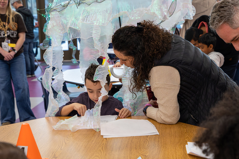 A parent with her student, who is dressed as a jellyfish