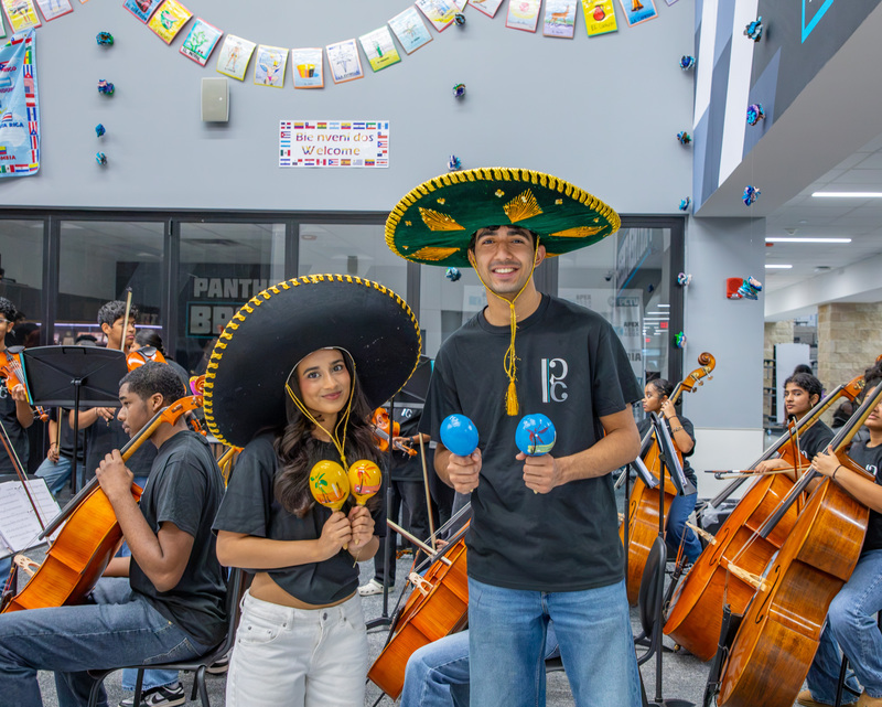 Orchestra students play the maracas