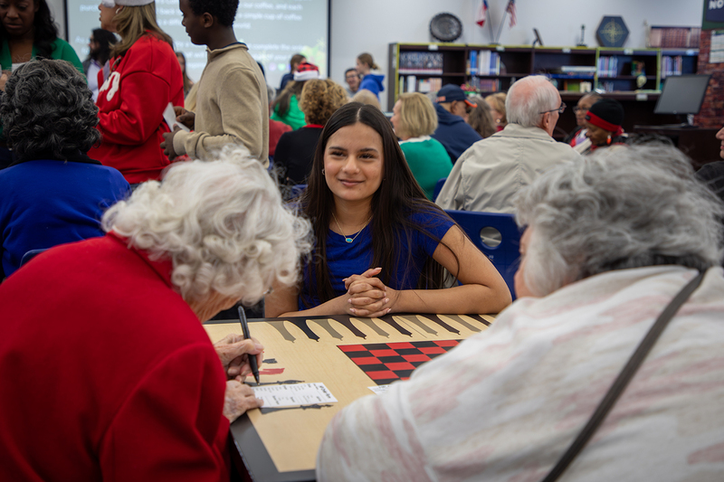 Hunt students help seniors fill out their coffee orders.