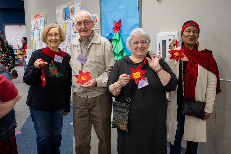 Seniors hold the ornaments they made.