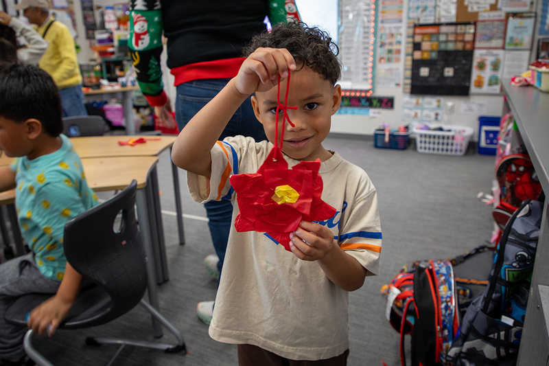 A Christie student shows off his ornament.
