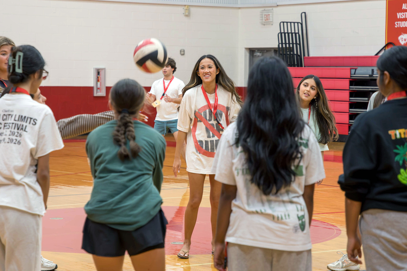 High schoolers play with a volleyball