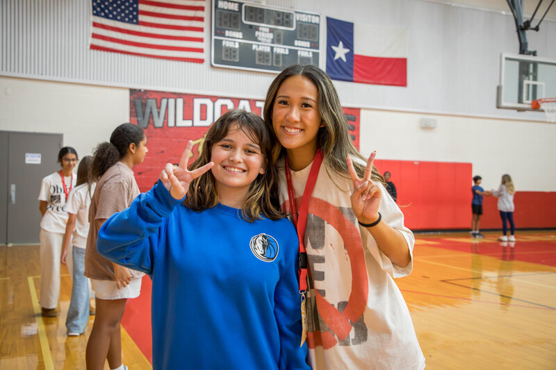 Riley flashes a peace sign with her PALee