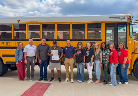 Group of people in front of a school bus