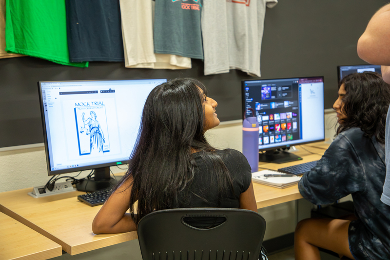 A graphic design student works on a bookmark design.