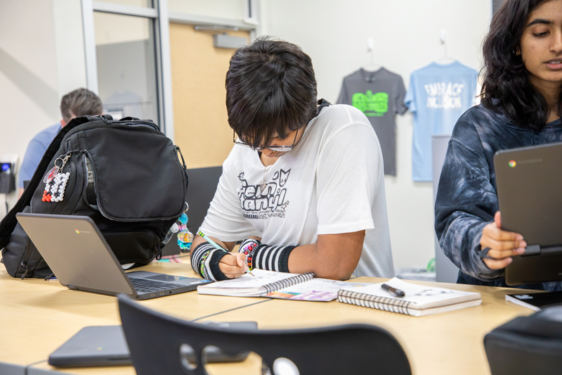 A graphic design student sketches their idea before working in Photoshop.