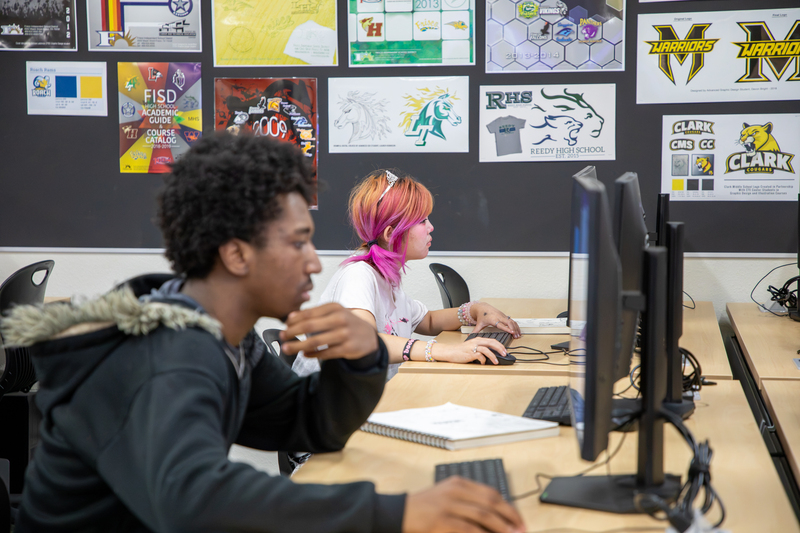 Graphic design students work on a bookmark design.