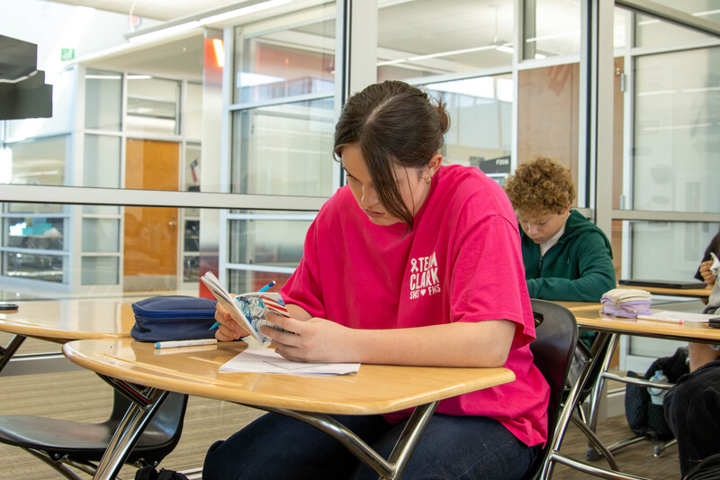 Government students look through their pocket Constitutions.