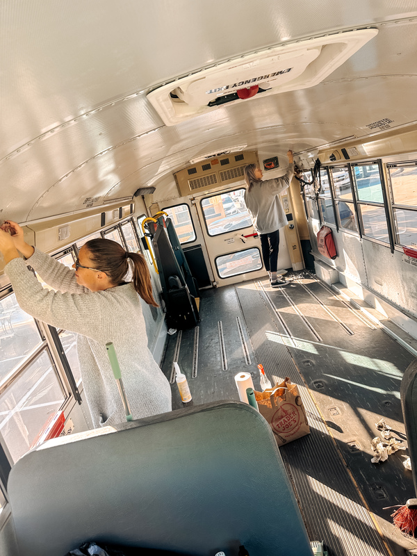 People working on the inside of a school bus
