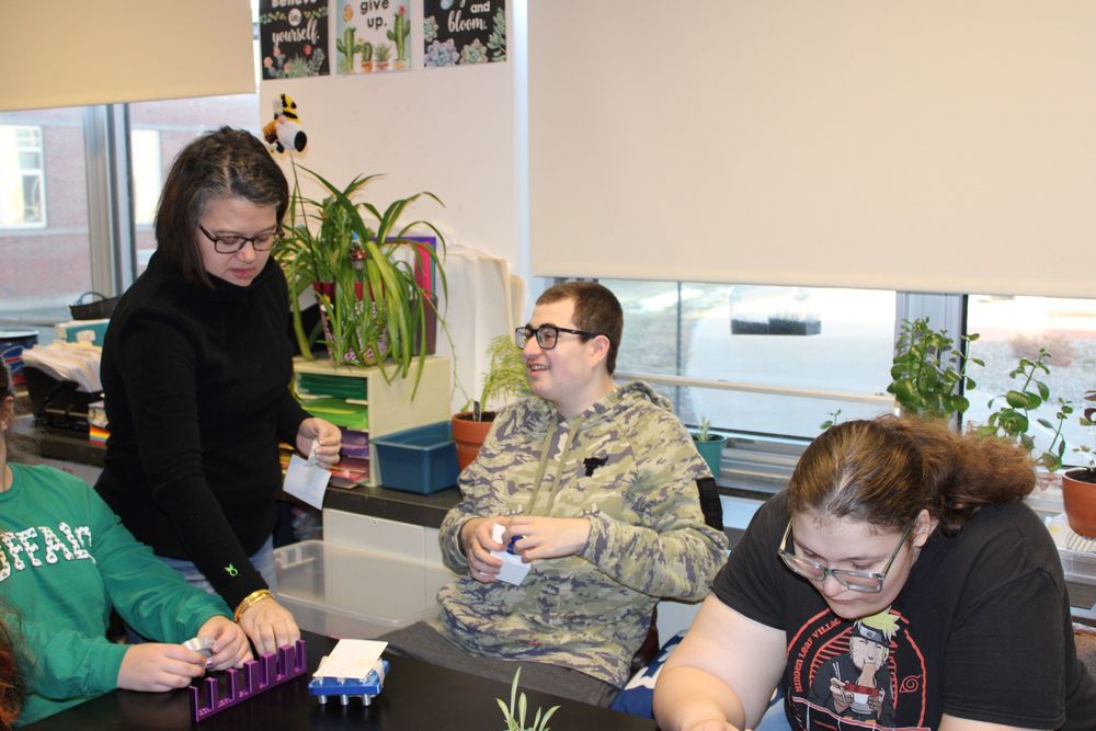 Teacher helping students