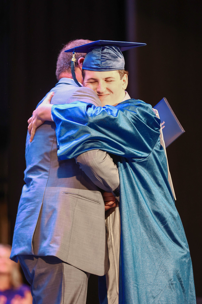 Principal congratulating student
