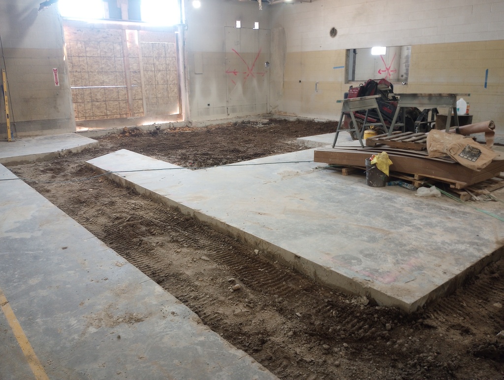 Cutting of floor making way for pipes in HS Science room.