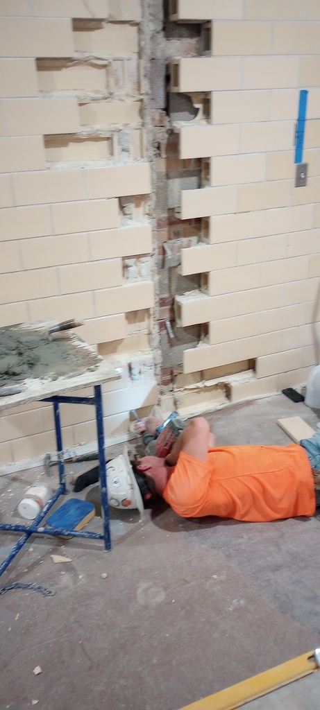 Preparing for the infilling of glazed block in the north hallway near the cafeteria.