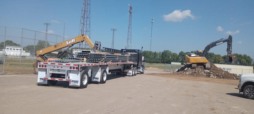 Delivery of roof joists and decking and the removal of asphalt in the west parking lot to allow for installation of roof drainage pipes later this fall.