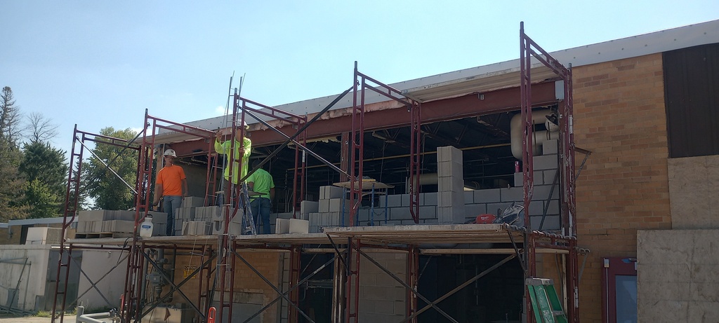 Infilling of wall openings and roughing in of new openings on the north wall of the boiler room.