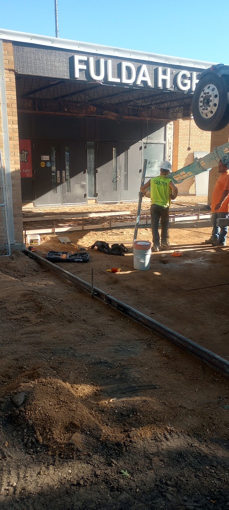 Pouring concrete on south side of building.