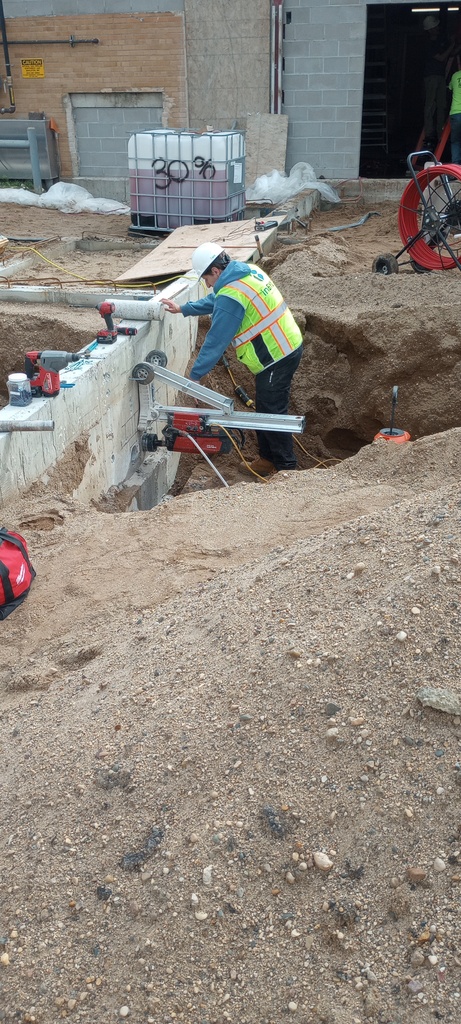 Drilling access for electrical service conduit on the East side of the North addition.
