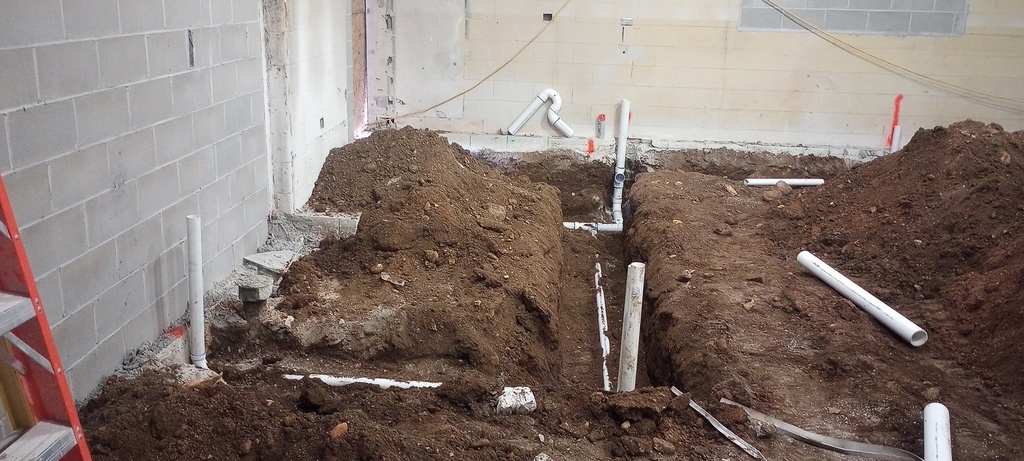 Installing waste pipe in the new Science Room.
